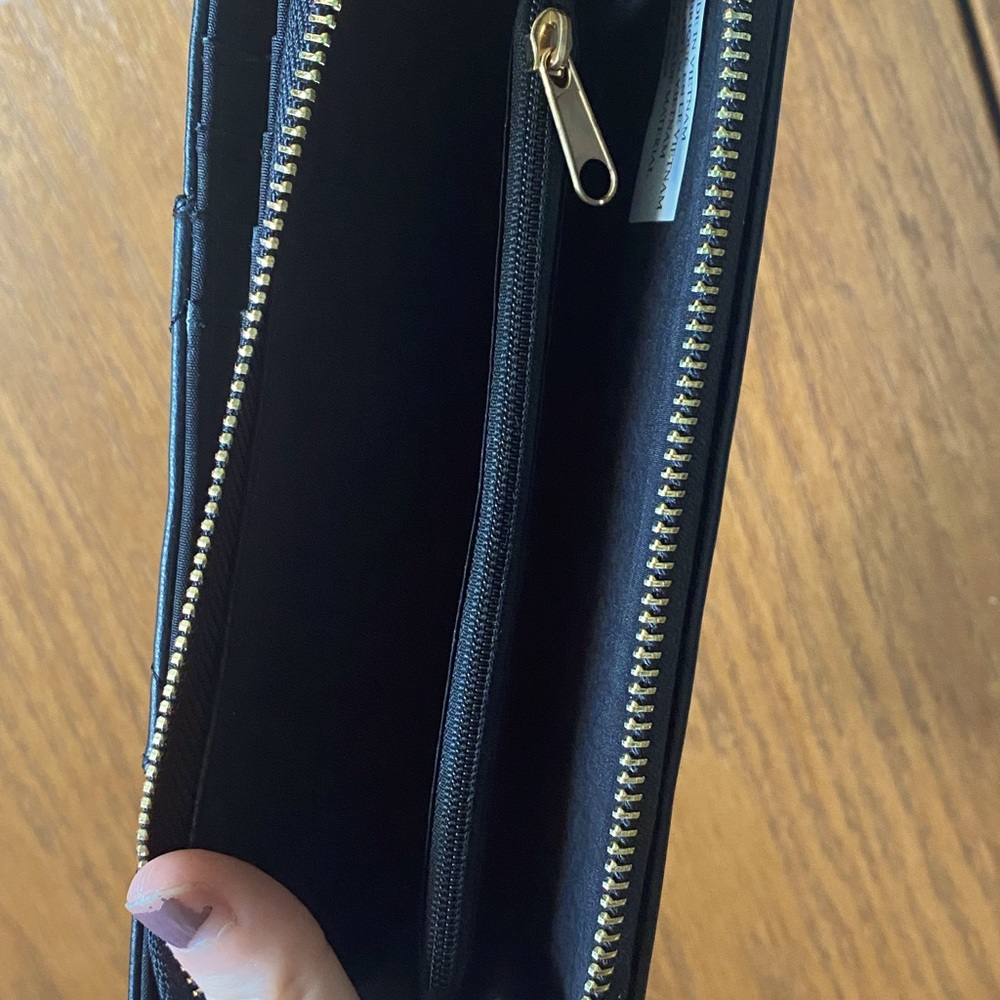 Black card and cash holder wallet, has a cute design on the front.